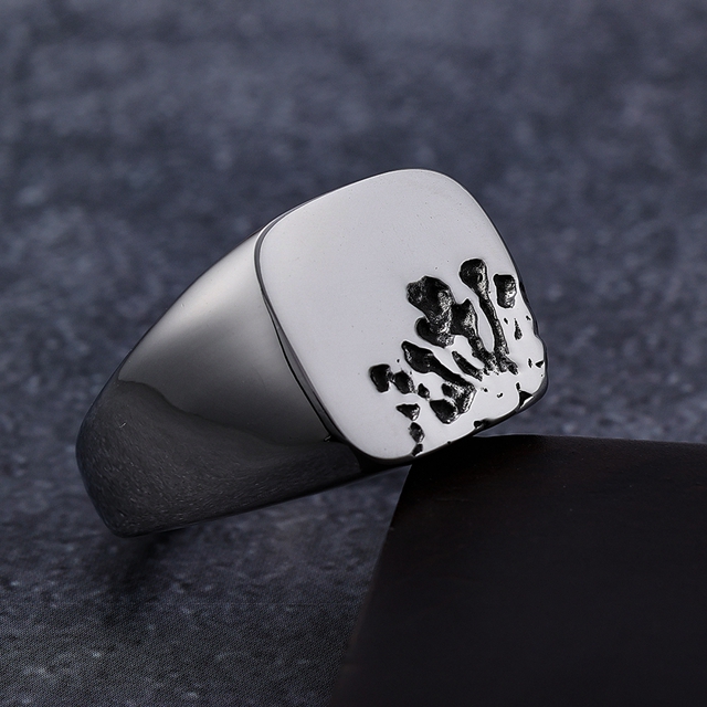 Angled detail view of polished stainless steel claw mark signet ring