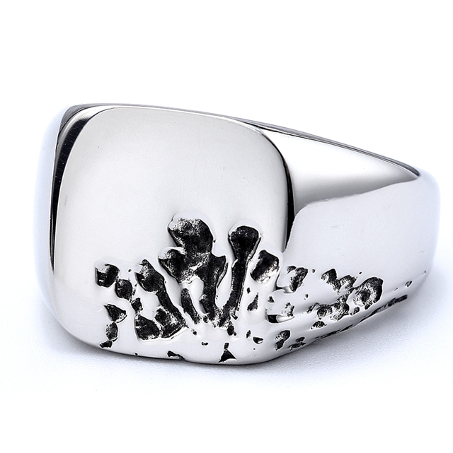 Stainless steel signet ring with black recessed claw mark texture on a white product background