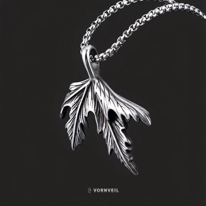 Vornveil maple leaf stainless steel pendant necklace on a dark background with silver logo watermark