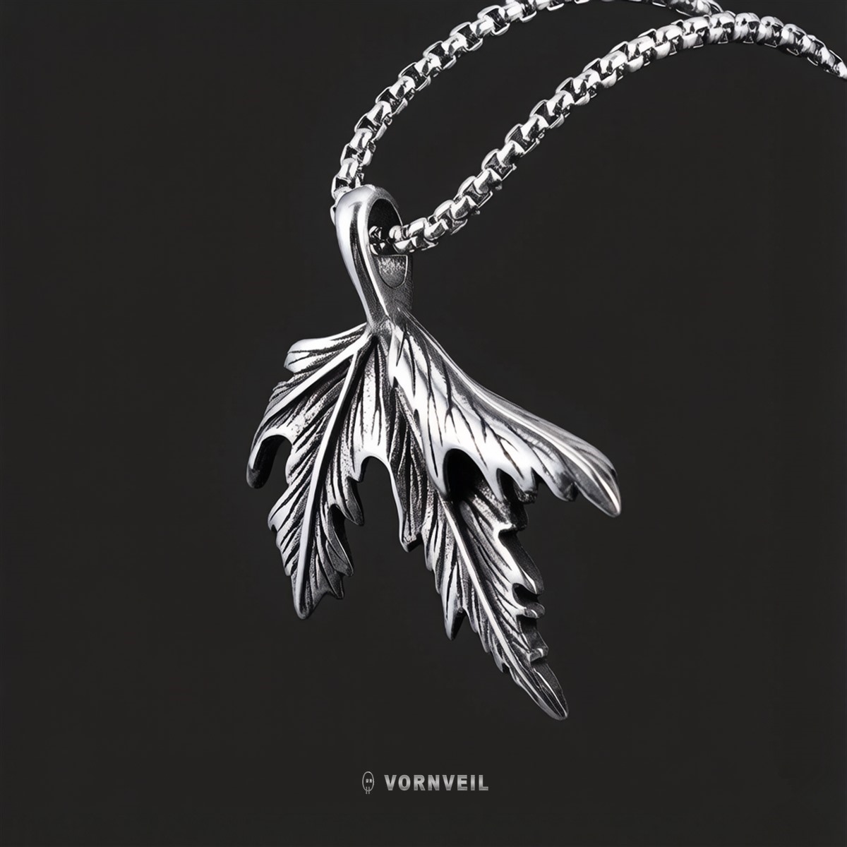 Vornveil maple leaf stainless steel pendant necklace on a dark background with silver logo watermark